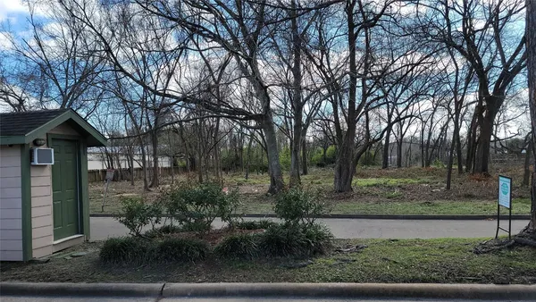 a view of a house with trees in the background