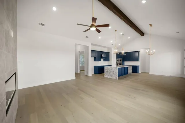 a view of a room with a window and a ceiling fan