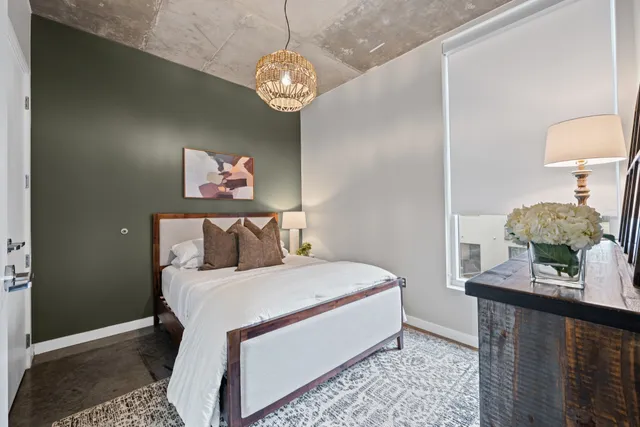 a bedroom with a bed and a lamp on table