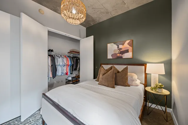 a bedroom with a bed and a chandelier