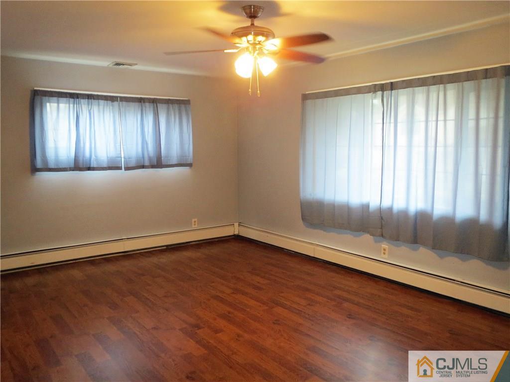 8 Sanders Road Edison, NJ 08817 - Photo 2 of 17 wooden floor in an empty room with a window