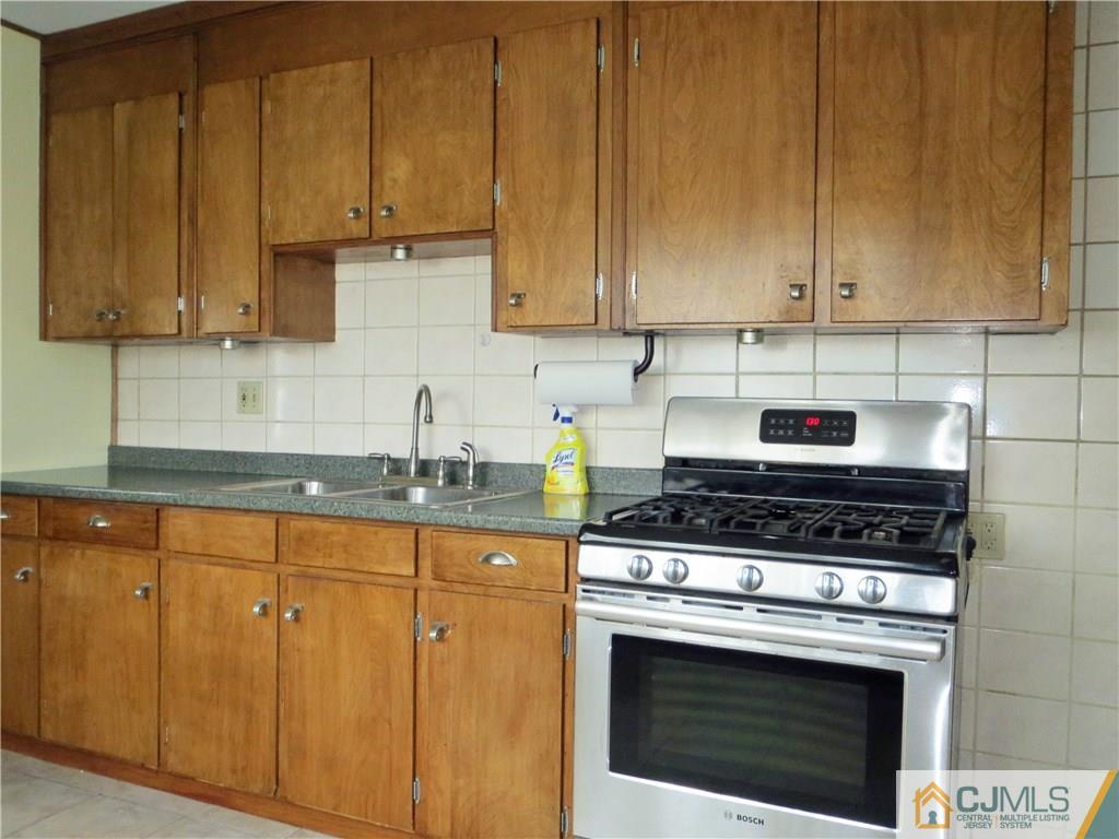 8 Sanders Road Edison, NJ 08817 - Photo 11 of 17 a kitchen with granite countertop wood cabinets and stainless steel appliances