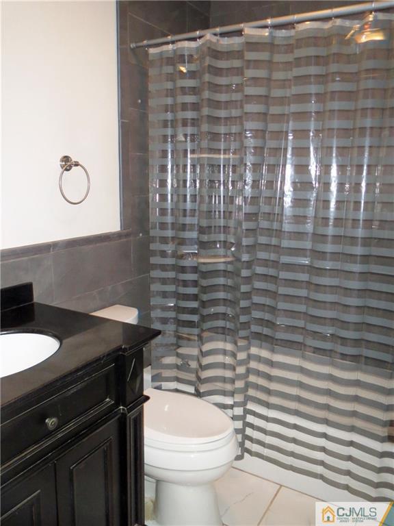 8 Sanders Road Edison, NJ 08817 - Photo 9 of 17 a bathroom with a sink and a toilet