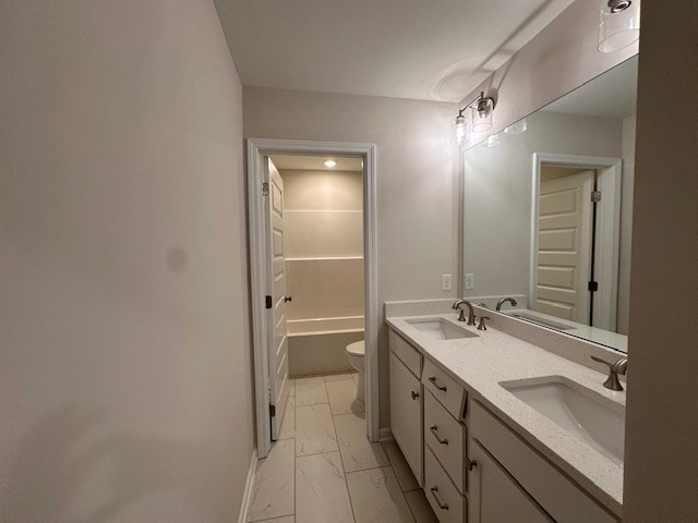 8715 McKee Road Upatoi, GA 31829 - Photo 17 of 29 a bathroom with a double vanity sink and mirror