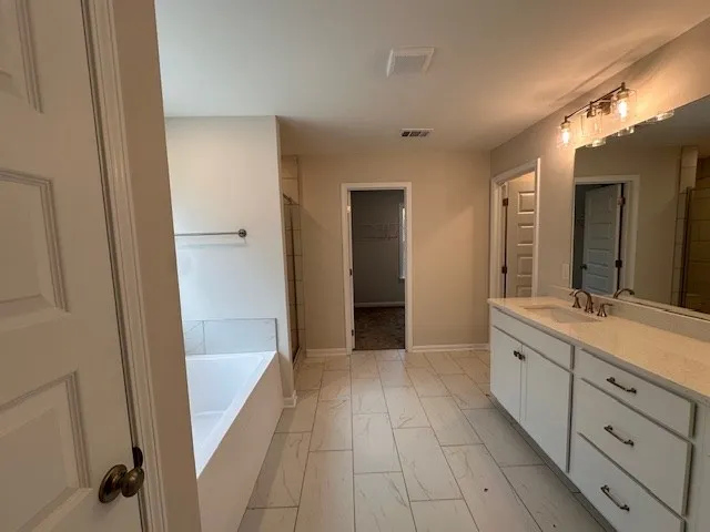 a bathroom with a double vanity sink and mirror with shower