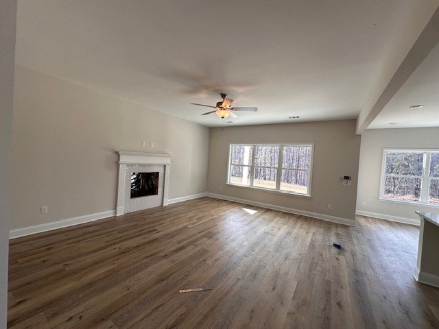 8715 McKee Road Upatoi, GA 31829 - Photo 4 of 29 an empty room with wooden floor fireplace and windows