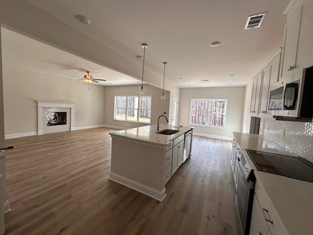 8715 McKee Road Upatoi, GA 31829 - Photo 6 of 29 a living room with fireplace furniture and a wooden floor