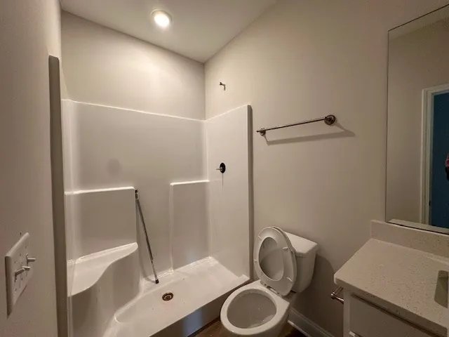 a bathroom with a sink toilet and shower