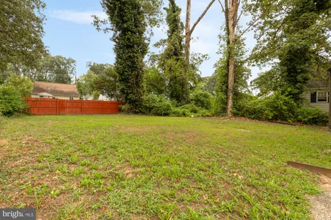 a view of house that has a big yard
