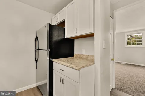 a kitchen with a refrigerator and cabinets