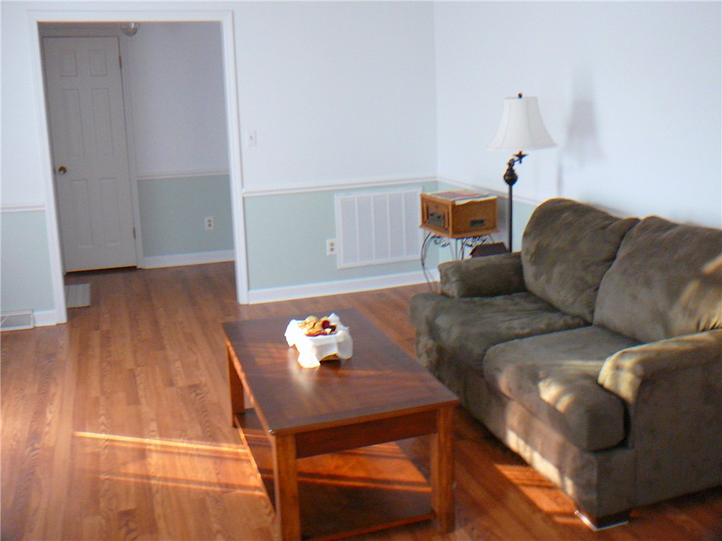 37 Camelia Circle Williamston, SC 29697 - Photo 3 of 25 This inviting living area boasts rich hardwood flooring and classic chair rail detailing.