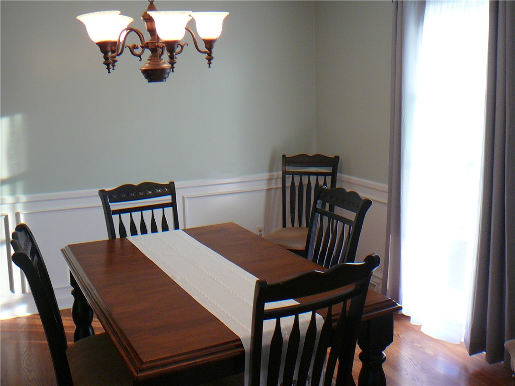 37 Camelia Circle Williamston, SC 29697 - Photo 4 of 25 This bright dining room features a warm chandelier and elegant wall trim.