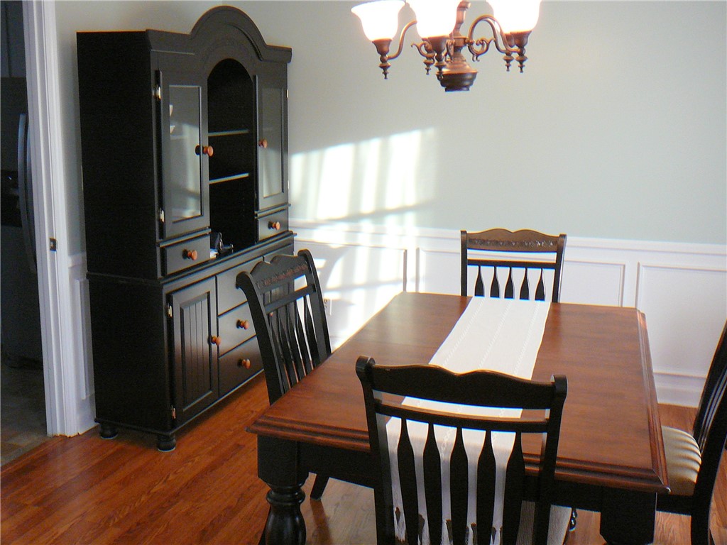 37 Camelia Circle Williamston, SC 29697 - Photo 5 of 25 This inviting dining area features rich wood flooring and classic wainscoting.