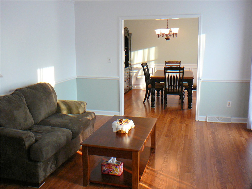 37 Camelia Circle Williamston, SC 29697 - Photo 6 of 25 This interior offers gleaming hardwood floors and an inviting dining area, ideal for gatherings.