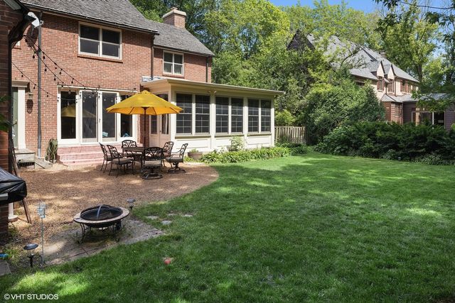 a view of a house with backyard sitting area and garden