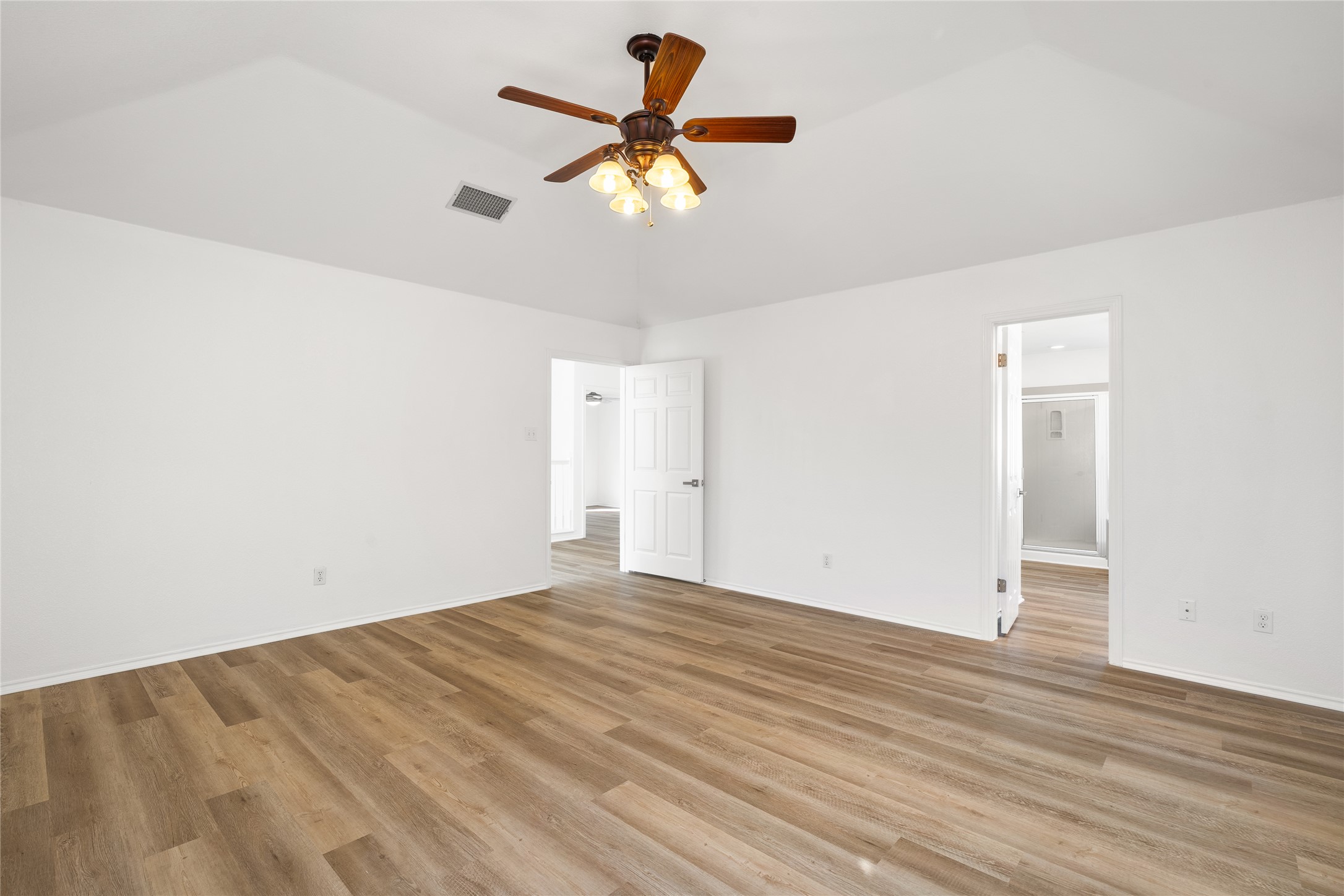206 River Down Road Georgetown, TX 78628 - Photo 30 of 39 Spacious interior featuring wood-finish flooring, vaulted ceiling, and a ceiling fan with integrated lighting