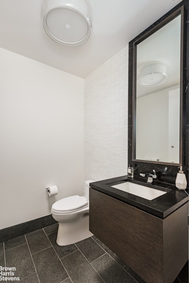 50 Riverside Boulevard, Unit 3H Manhattan, NY 10069 - Photo 11 of 21 a bathroom with a sink and a mirror