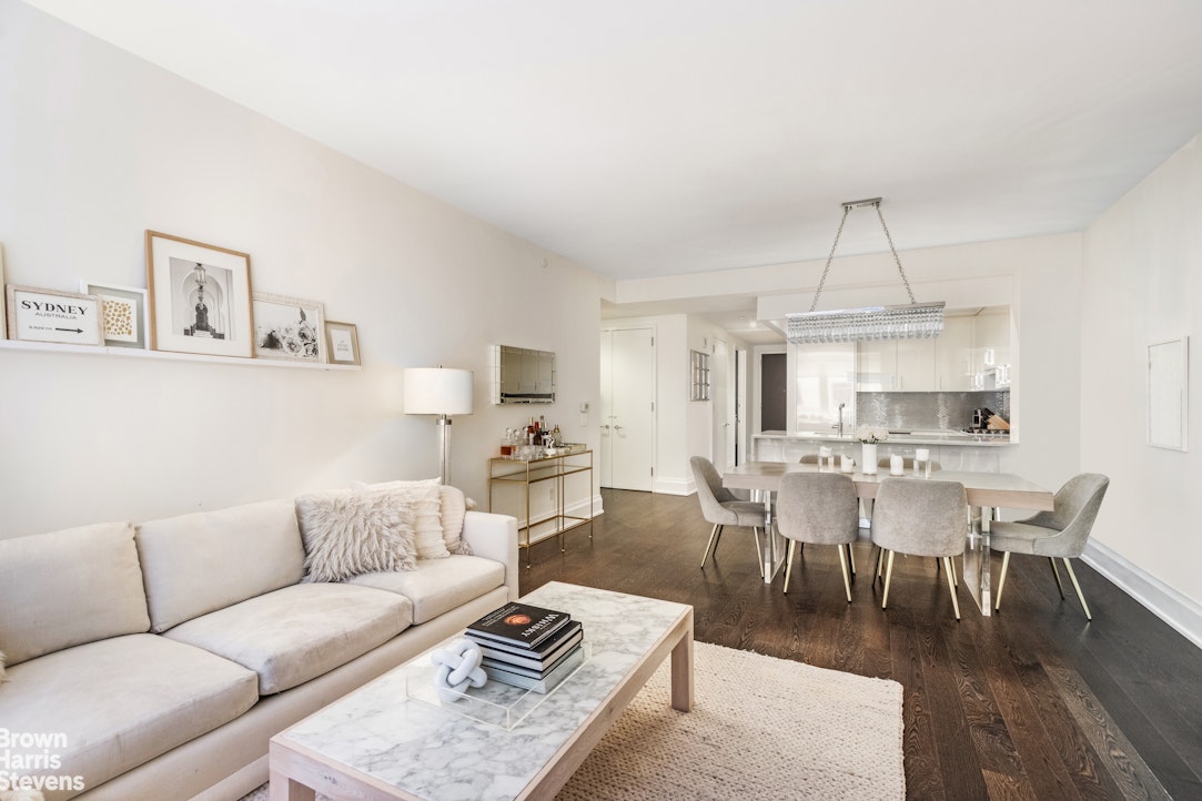 50 Riverside Boulevard, Unit 3H Manhattan, NY 10069 - Photo 2 of 21 a living room with furniture a rug and a dining table