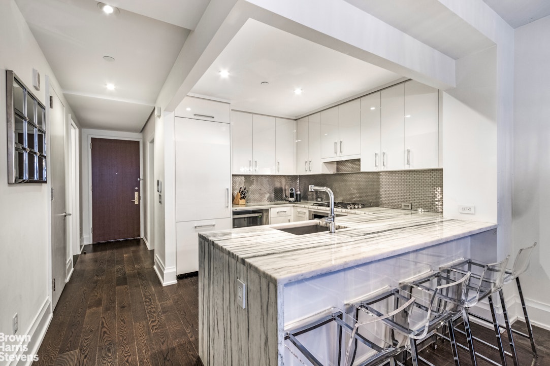 50 Riverside Boulevard, Unit 3H Manhattan, NY 10069 - Photo 3 of 21 a kitchen with a sink a stove a refrigerator and cabinets
