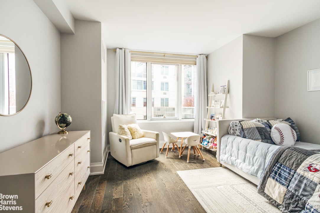 50 Riverside Boulevard, Unit 3H Manhattan, NY 10069 - Photo 8 of 21 a living room with furniture and a large window