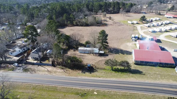 a view of swimming pool with a yard and plants