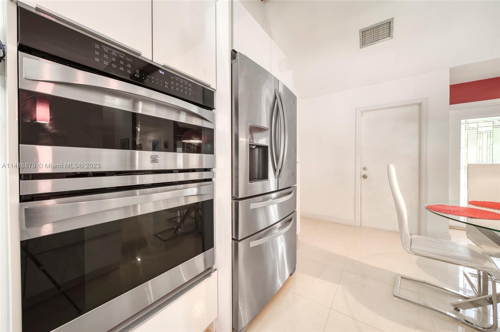 9904 Southwest 133rd Court Miami, FL 33186 - Photo 25 of 43 a kitchen with stainless steel appliances and cabinets