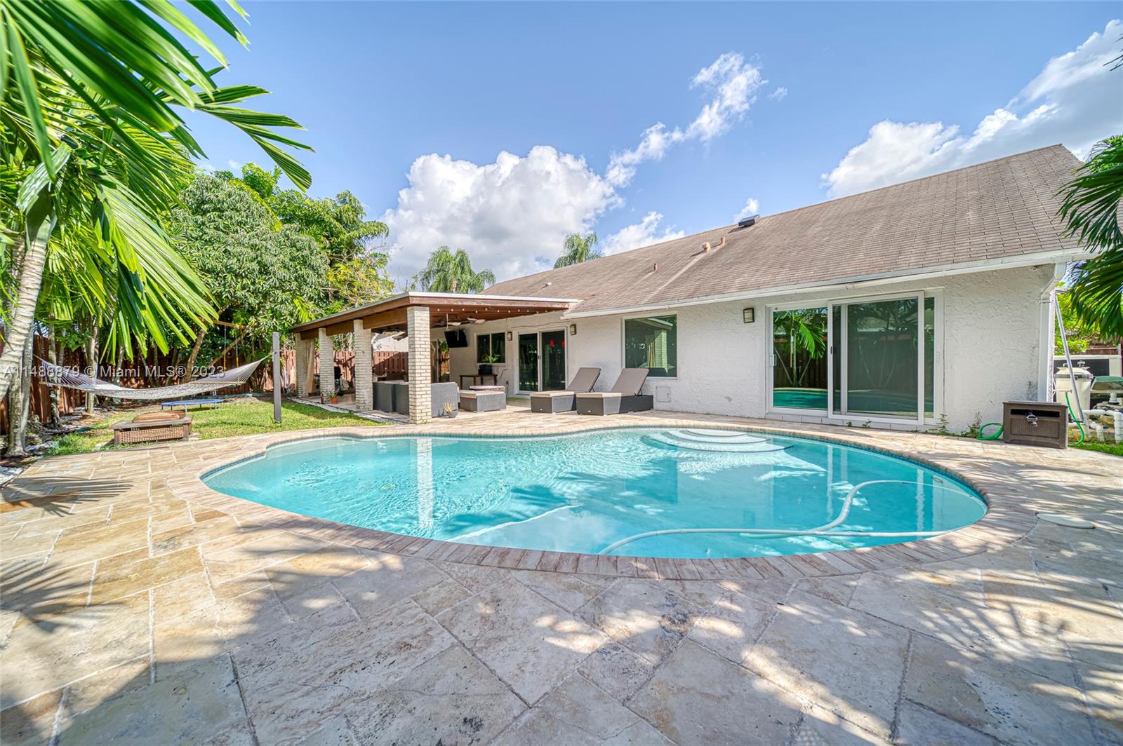 9904 Southwest 133rd Court Miami, FL 33186 - Photo 30 of 43 a view of a house with pool and chairs