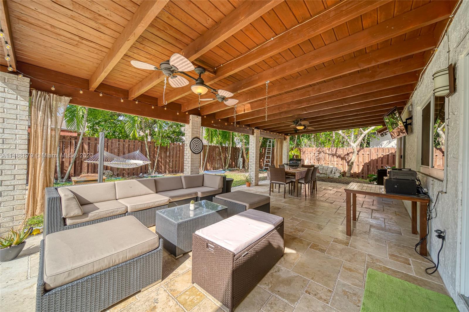 9904 Southwest 133rd Court Miami, FL 33186 - Photo 32 of 43 a outdoor space with lots of tables a large mirror and a glass door