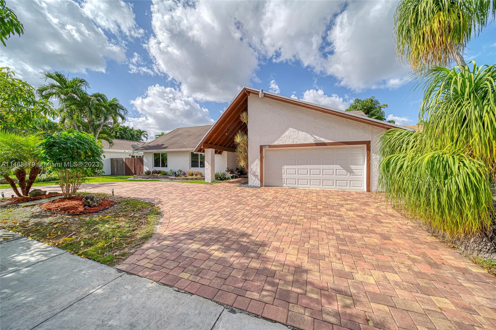 9904 Southwest 133rd Court Miami, FL 33186 - Photo 35 of 43 a front view of a house with a yard and a garage