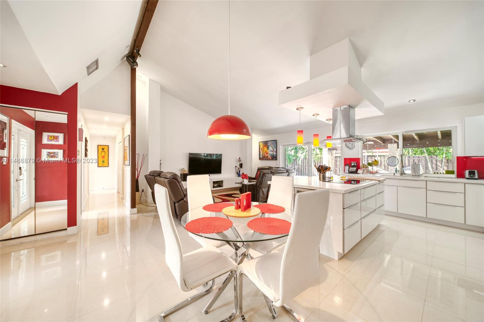 9904 Southwest 133rd Court Miami, FL 33186 - Photo 6 of 43 a kitchen with stainless steel appliances kitchen island granite countertop a table and chairs in it