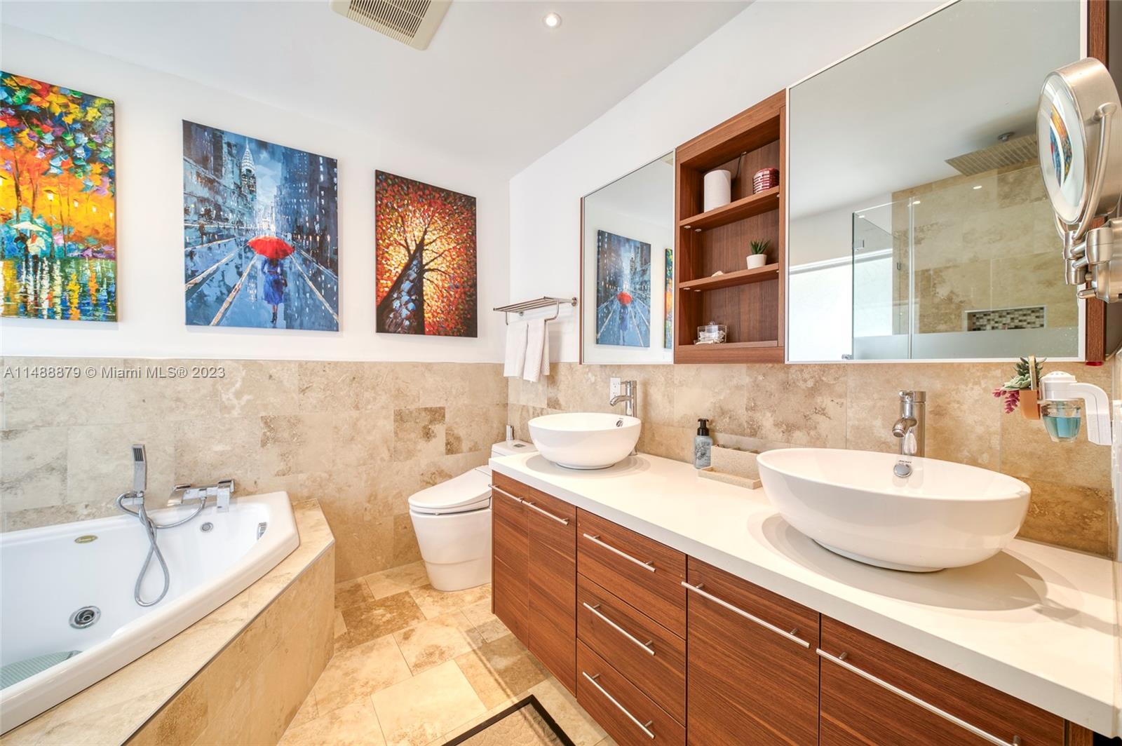 9904 Southwest 133rd Court Miami, FL 33186 - Photo 8 of 43 a spacious bathroom with double vanity sinks a large mirror a bathtub and shower