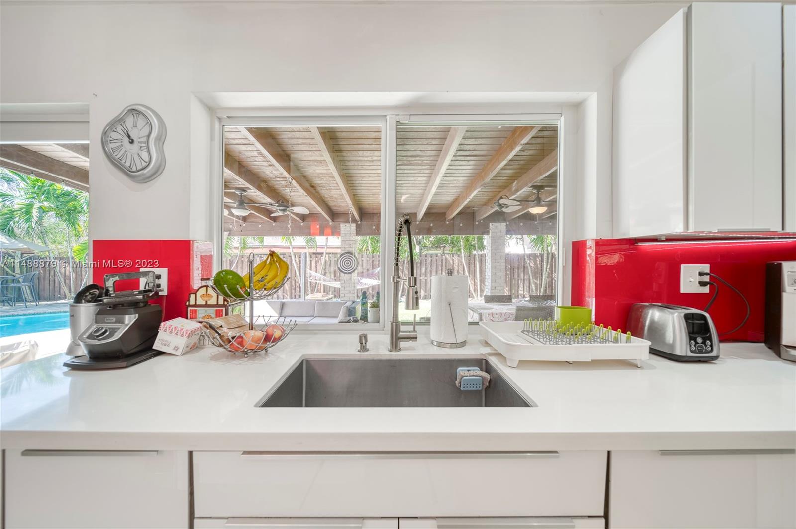 9904 Southwest 133rd Court Miami, FL 33186 - Photo 9 of 43 a kitchen with a sink and a chandelier