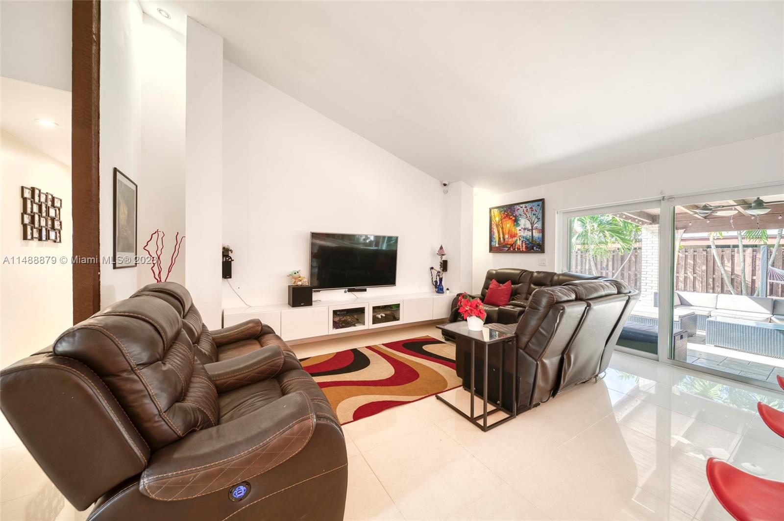 9904 Southwest 133rd Court Miami, FL 33186 - Photo 10 of 43 a living room with furniture and a flat screen tv