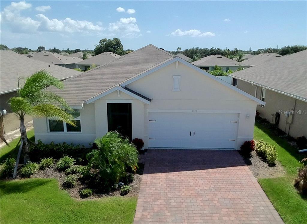 8992 Excelsior Loop Venice, FL 34293 - Photo 1 of 1 a view of a house with a yard and potted plants