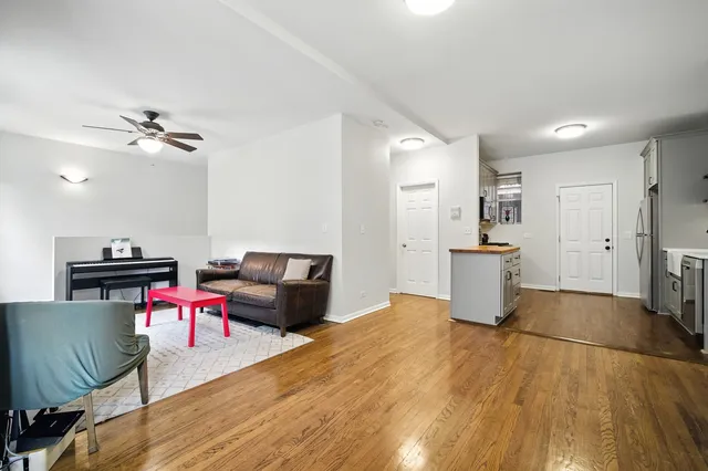 a living room with furniture and kitchen view
