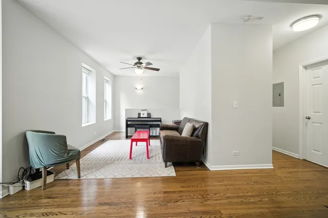 a living room with furniture and a wooden floor
