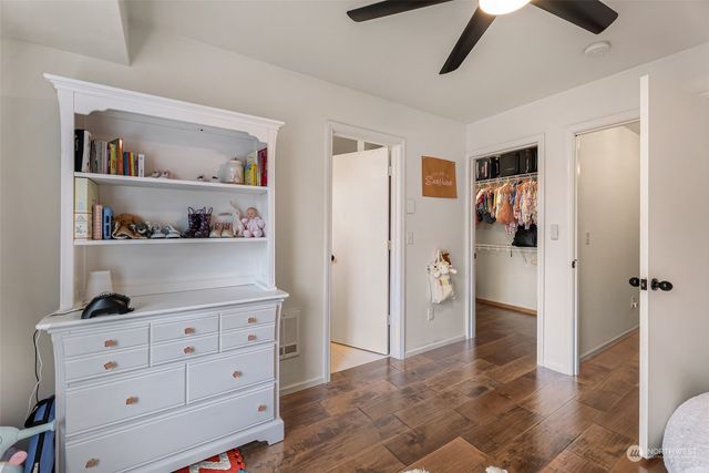 a bathroom with a sink a toilet a mirror and shower curtain