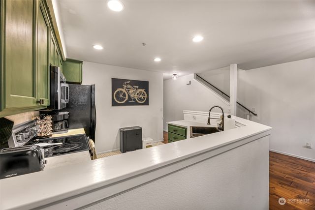 a living room with furniture and a ceiling fan