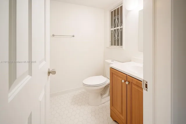 a bathroom with a toilet a sink and a window