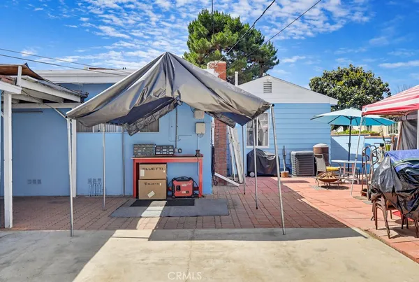 a view of the patio with table and chairs under an umbrella