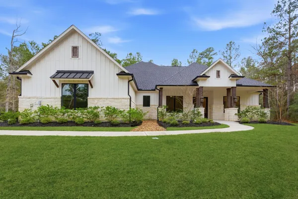 a front view of a house with a yard porch and outdoor seating