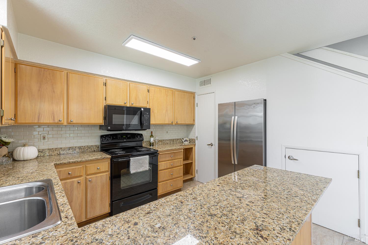 2773 Elks Way Napa, CA 94558 - Photo 16 of 39 a kitchen with stainless steel appliances granite countertop a sink stove and refrigerator