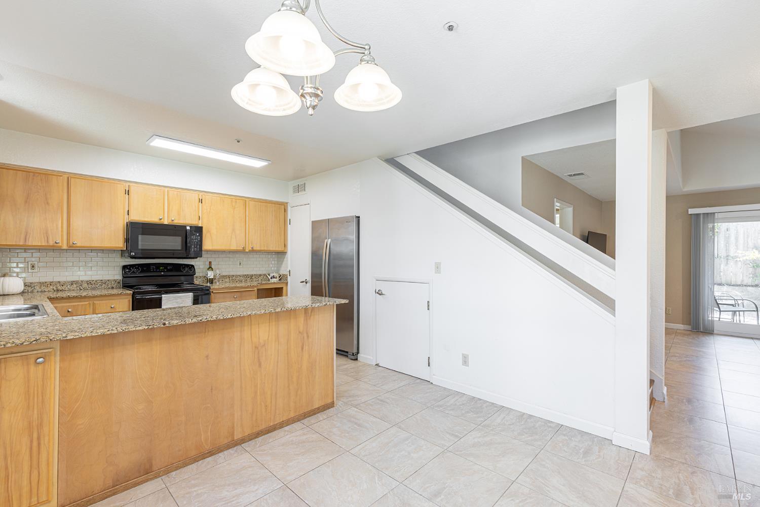 2773 Elks Way Napa, CA 94558 - Photo 20 of 39 a kitchen with stainless steel appliances a stove refrigerator sink and microwave