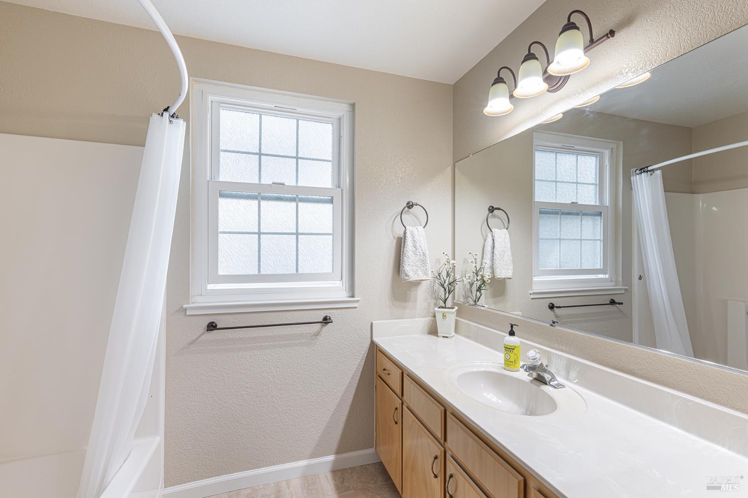 2773 Elks Way Napa, CA 94558 - Photo 33 of 39 a bathroom with a sink a vanity and a mirror