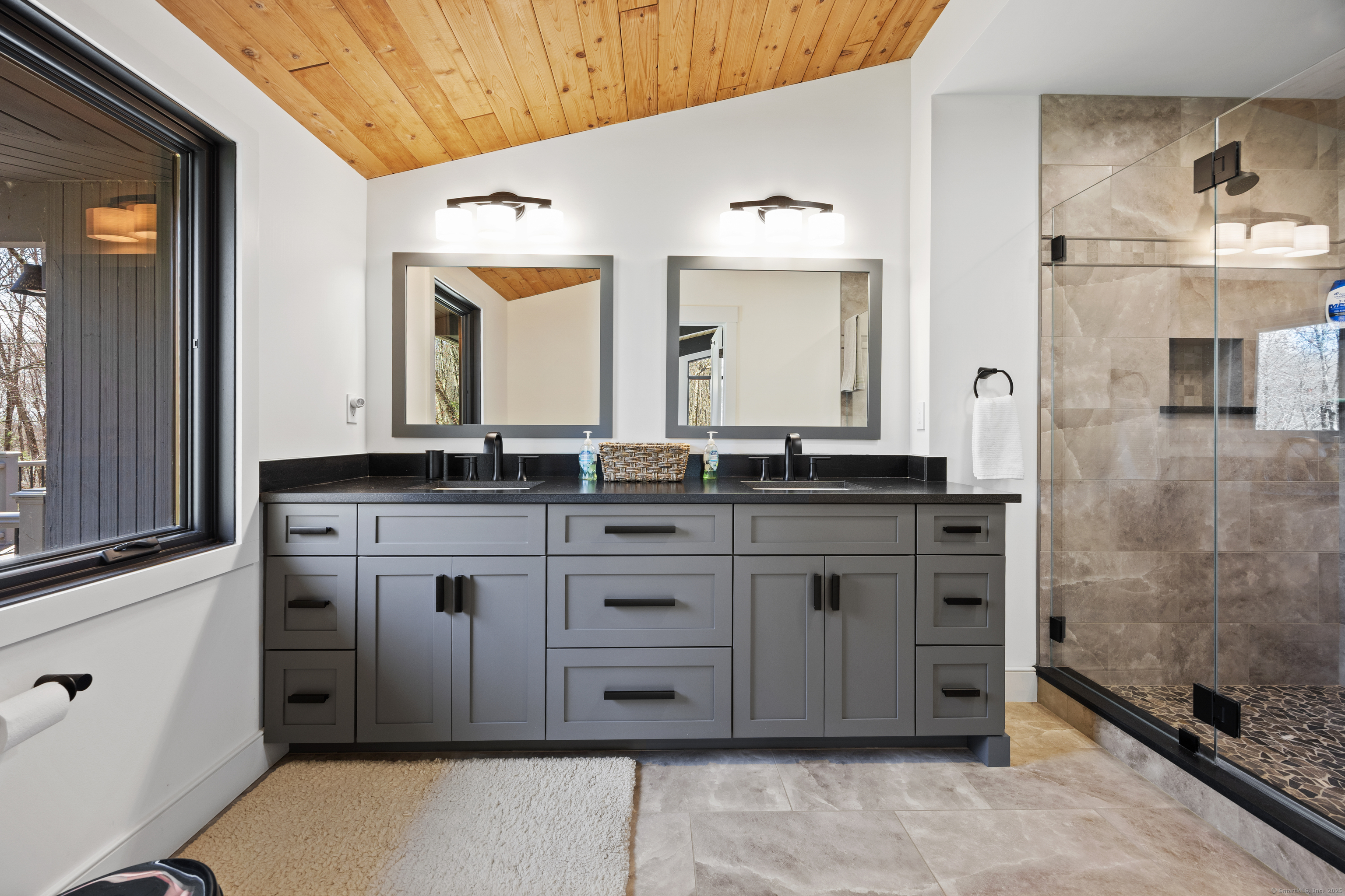 187 Sherbrook Drive Goshen, CT 06756 - Photo 22 of 39 a spacious bathroom with a granite countertop sink and a mirror