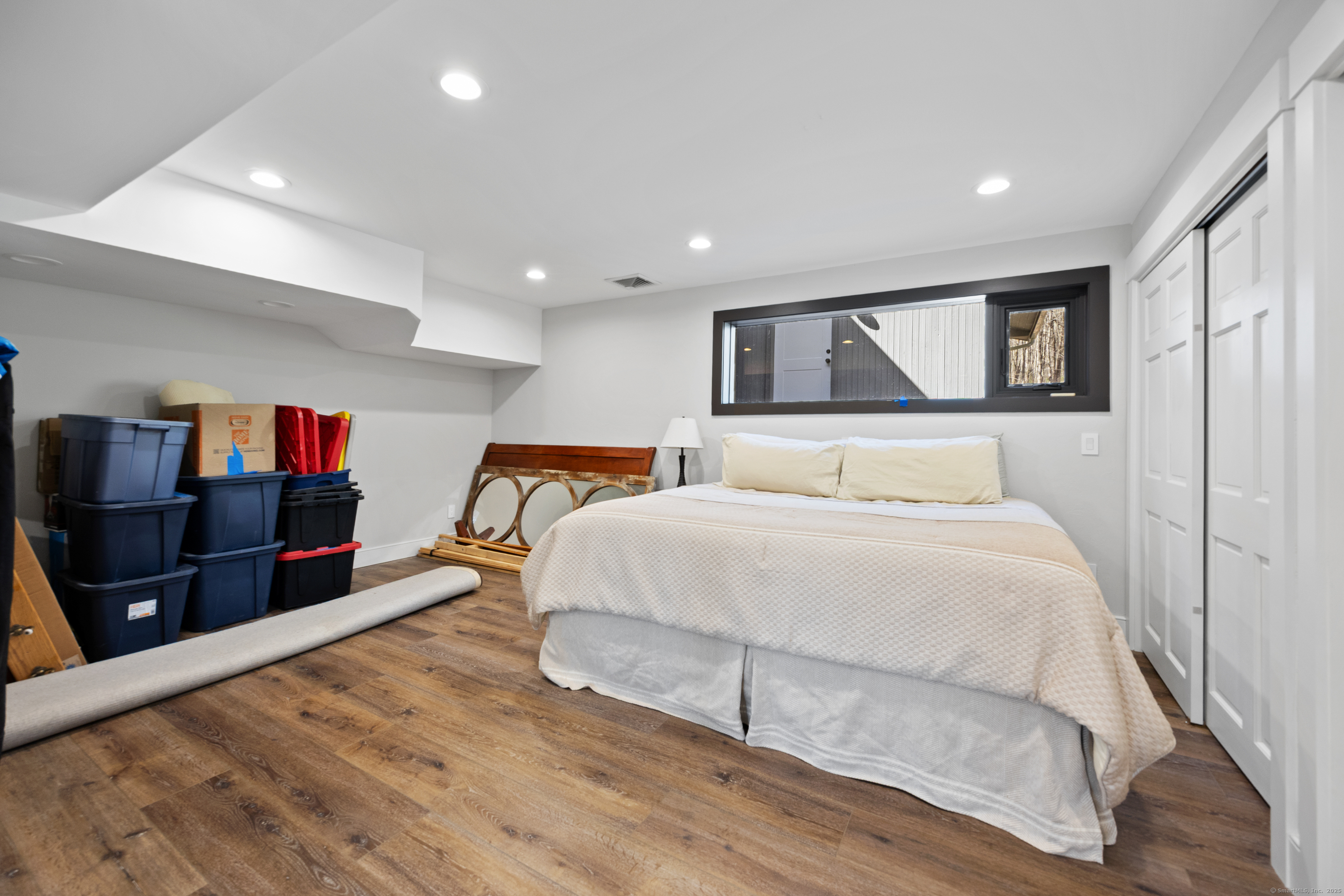 187 Sherbrook Drive Goshen, CT 06756 - Photo 34 of 39 a spacious bedroom with a bed and wooden floor