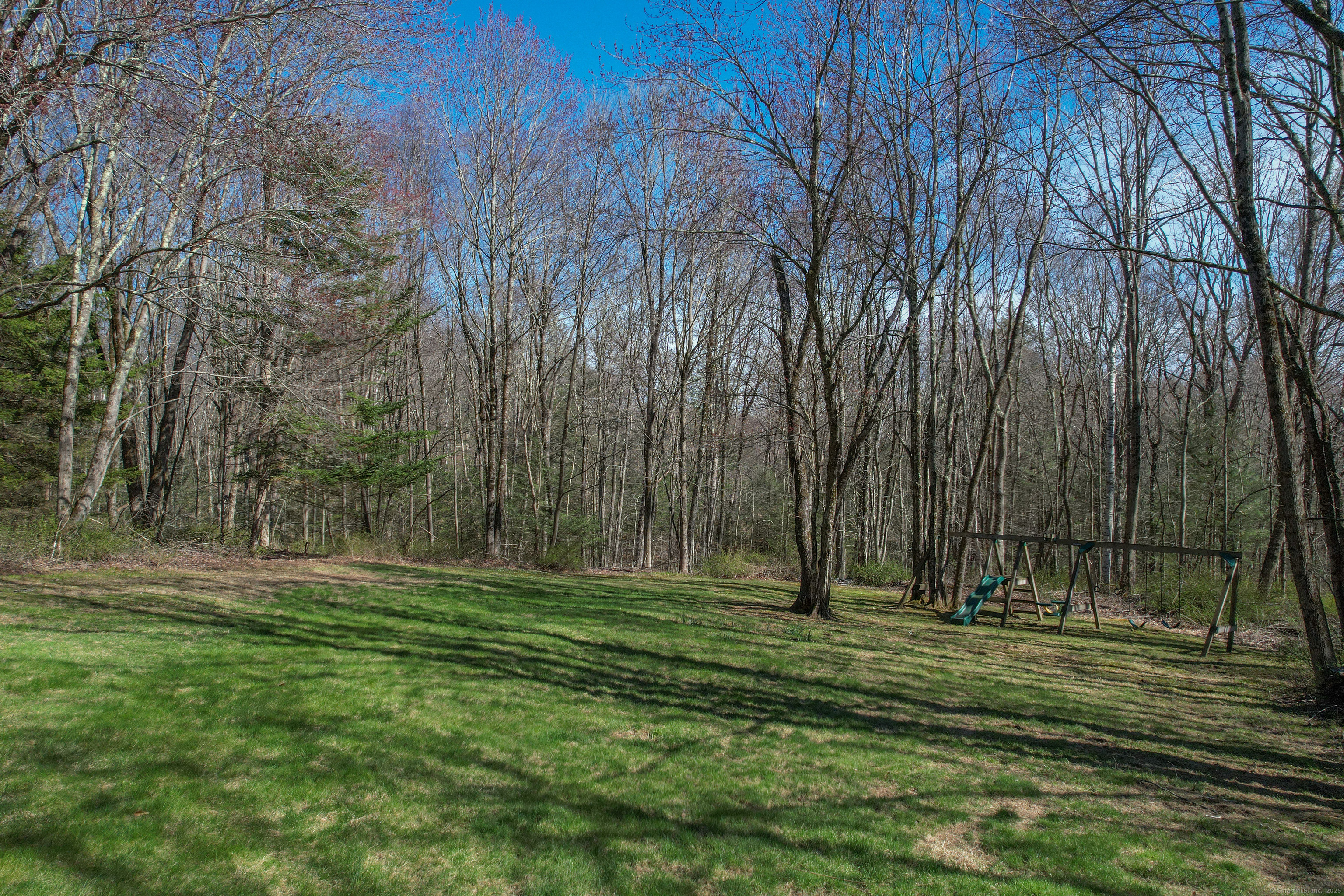 187 Sherbrook Drive Goshen, CT 06756 - Photo 7 of 39 a backyard of apartments with large trees
