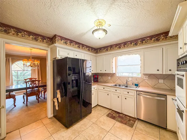 a kitchen with a sink appliances and cabinets