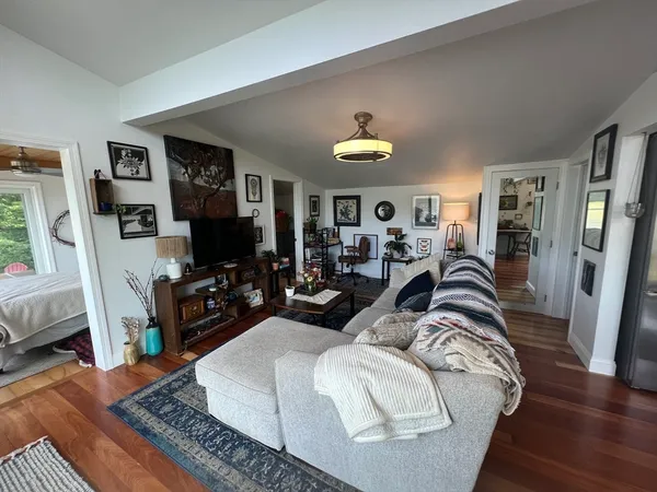 a living room with furniture fireplace and flat screen tv