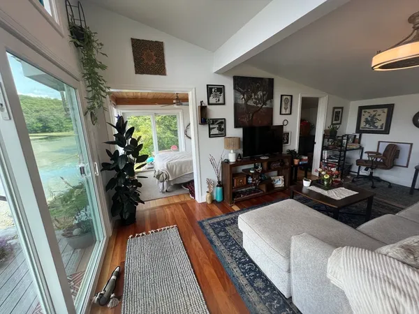 a bedroom with bed and balcony